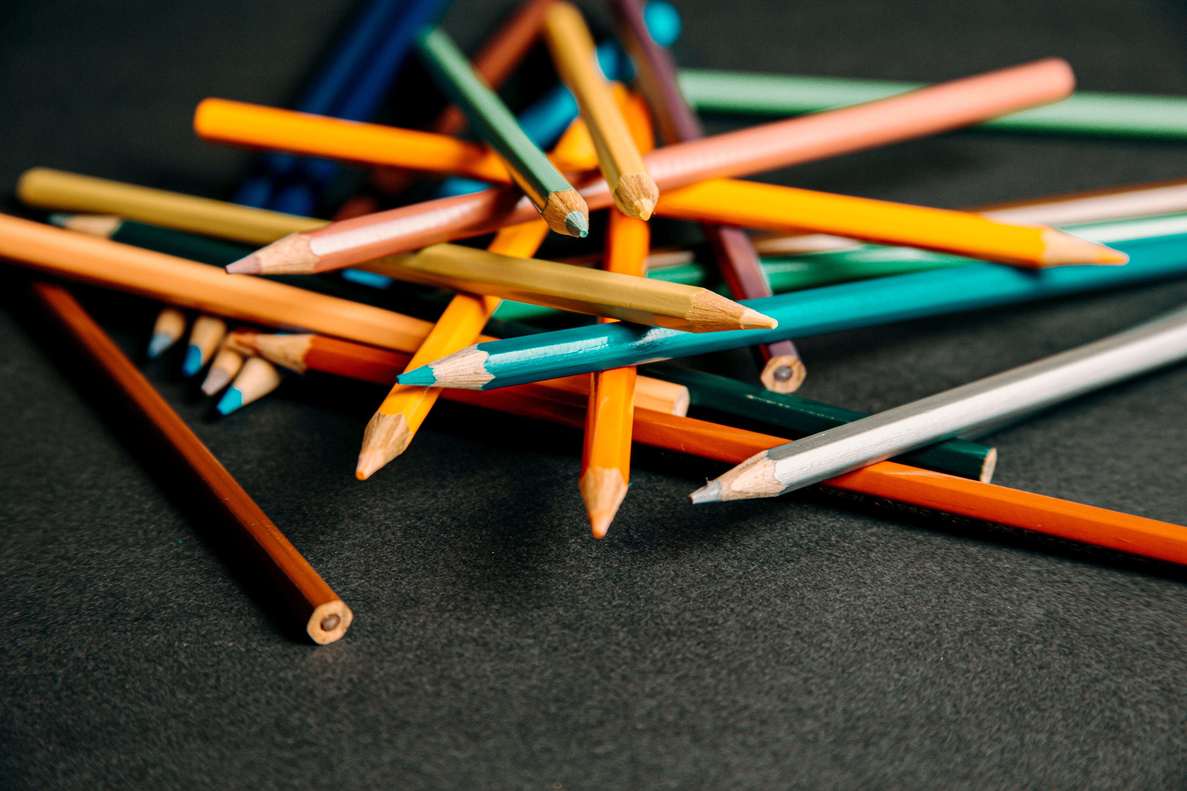 colored-pencils-piled-up-on-a-black-background.jpg